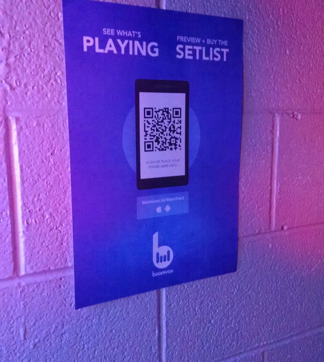 In-venue poster reading See what's playing, preview and buy the setlist, with a QR code and NFC tap target
